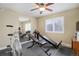 Well-equipped home gym featuring fitness equipment, a ceiling fan, and large mirror at 10914 W Coco Pl, Littleton, CO 80127