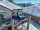 Elevated deck featuring a hot tub, seating area, and stone pillars for outdoor enjoyment at 10914 W Coco Pl, Littleton, CO 80127