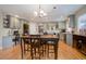 Spacious kitchen with gray cabinets, a breakfast table, and modern lighting fixtures at 10914 W Coco Pl, Littleton, CO 80127