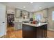 Kitchen featuring granite countertops, custom cabinets, hardwood floors, and stainless steel appliances at 10914 W Coco Pl, Littleton, CO 80127