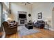 Bright living room featuring fireplace, hardwood floors, and large windows for lots of natural light at 10914 W Coco Pl, Littleton, CO 80127