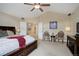 Main bedroom features a tray ceiling, carpet, and an ensuite bathroom at 10914 W Coco Pl, Littleton, CO 80127