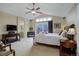 Main bedroom featuring a ceiling fan, television, carpet, and a private deck at 10914 W Coco Pl, Littleton, CO 80127