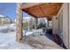 Covered patio with stone pillars, outdoor furniture, and string lights for cozy outdoor dining at 10914 W Coco Pl, Littleton, CO 80127