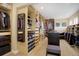 A well-organized walk-in closet with custom shelving, hanging rods, and storage drawers for clothes and accessories at 10914 W Coco Pl, Littleton, CO 80127