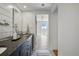 Bright bathroom featuring a dark countertop, and an open doorway leading to a bedroom at 700 N Washington St # 1104, Denver, CO 80203