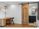 Office space featuring hardwood floors, desk, sliding barn door leading to the bathroom, and shelves at 700 N Washington St # 1104, Denver, CO 80203
