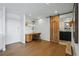 Office space featuring hardwood floors, desk, sliding barn door leading to the bathroom and overhead lights at 700 N Washington St # 1104, Denver, CO 80203