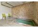 Relaxing hot tub area with brick wall, tiled floor, and seating at 700 N Washington St # 1104, Denver, CO 80203