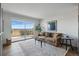 Living room showcasing a sliding glass door to the balcony and a comfortable seating area at 700 N Washington St # 1104, Denver, CO 80203