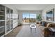 Living room featuring a balcony with city views, hardwood floors and a decorative shelving unit at 700 N Washington St # 1104, Denver, CO 80203