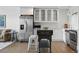 Open living space featuring hardwood floors, stainless steel appliances, and a combined living and kitchen area at 700 N Washington St # 1104, Denver, CO 80203