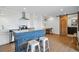 Open living space featuring hardwood floors, stainless steel appliances, and a sliding barn door at 700 N Washington St # 1104, Denver, CO 80203