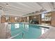 Bright indoor pool area with large windows, brick walls, and tiled floor at 700 N Washington St # 1104, Denver, CO 80203