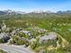 Scenic aerial view of a mountain community nestled amongst evergreen trees with snow-capped mountains in the background at 50 Mountain Thunder Dr # 1402, Breckenridge, CO 80424