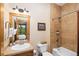 Bathroom with tiled shower, wood vanity and mirror with view of trees and sky at 50 Mountain Thunder Dr # 1402, Breckenridge, CO 80424