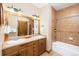 Well-lit bathroom with a double sink vanity, tiled shower/bath combination, and ample storage space at 50 Mountain Thunder Dr # 1402, Breckenridge, CO 80424