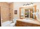 Bathroom with tiled shower, wood vanity and mirror reflecting bedroom in background at 50 Mountain Thunder Dr # 1402, Breckenridge, CO 80424