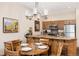 Charming kitchen with wood cabinets, granite counters, and a cozy breakfast bar with seating for casual dining at 50 Mountain Thunder Dr # 1402, Breckenridge, CO 80424