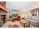 Cozy living room with a stone fireplace, comfortable seating, and a large window with scenic mountain views at 50 Mountain Thunder Dr # 1402, Breckenridge, CO 80424