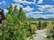 Mountain view from property overlooking neighborhood with trees, buildings, and cloudy sky at 50 Mountain Thunder Dr # 1402, Breckenridge, CO 80424