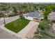 Aerial view of home on landscaped lot with city skyline in the distance at 4640 W Ellsworth Ave, Denver, CO 80219
