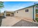 Backyard patio with gravel landscaping, wood fence, and home elevation at 4640 W Ellsworth Ave, Denver, CO 80219