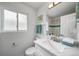 Bright bathroom with marble vanity top, stylish sink and a framed mirror at 4640 W Ellsworth Ave, Denver, CO 80219