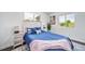 Bright bedroom features a large window, neutral decor, and creates a relaxing space at 4640 W Ellsworth Ave, Denver, CO 80219