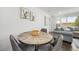 Cozy dining area next to the kitchen features a round table and access to living room at 4640 W Ellsworth Ave, Denver, CO 80219
