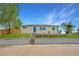 Charming home featuring a well-maintained lawn, rock garden, and a bright blue front door at 4640 W Ellsworth Ave, Denver, CO 80219