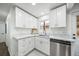 Bright modern kitchen featuring stainless steel appliances, white cabinets, and a window above the sink at 4640 W Ellsworth Ave, Denver, CO 80219