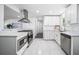 Modern kitchen featuring stainless steel appliances, bright white cabinetry, and a sleek design at 4640 W Ellsworth Ave, Denver, CO 80219