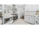 Modern kitchen with stainless steel appliances and light stone countertops, perfect for cooking and entertaining at 4640 W Ellsworth Ave, Denver, CO 80219