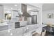 Sleek kitchen with marble countertops, stainless steel appliances, and a stylish range hood at 4640 W Ellsworth Ave, Denver, CO 80219