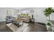 Bright living room with hardwood floors, modern furniture, and large windows at 4640 W Ellsworth Ave, Denver, CO 80219