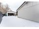 Backyard with detached garage and patio furniture, covered in snow at 12029 W Dakota Dr, Lakewood, CO 80228