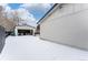 Backyard with detached garage and patio furniture, covered in snow at 12029 W Dakota Dr, Lakewood, CO 80228