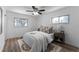 Cozy bedroom with a queen-size bed, ceiling fan, and wood-look floors at 12029 W Dakota Dr, Lakewood, CO 80228