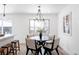 Bright dining room with a round table, chandelier, and hardwood floors at 12029 W Dakota Dr, Lakewood, CO 80228