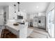 Modern white kitchen with stainless steel appliances and quartz countertops at 12029 W Dakota Dr, Lakewood, CO 80228