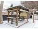 Covered patio with pergola, seating area, and snow covered ground at 12029 W Dakota Dr, Lakewood, CO 80228