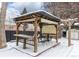 Covered patio with pergola, seating area, and snow covered ground at 12029 W Dakota Dr, Lakewood, CO 80228