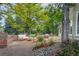 Inviting brick patio with outdoor seating and lush landscaping, perfect for entertaining guests at 7 Mockingbird Ln, Cherry Hills Village, CO 80113