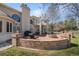 Backyard brick patio features an outdoor kitchen, lounge area, and manicured lawn at 7 Mockingbird Ln, Cherry Hills Village, CO 80113