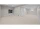 Spacious finished basement with carpet, a small window, and multiple access doors at 7 Mockingbird Ln, Cherry Hills Village, CO 80113