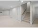 Finished basement area with neutral carpet flooring, white doors, and a staircase at 7 Mockingbird Ln, Cherry Hills Village, CO 80113