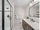 The bathroom features a walk-in shower, vanity with double sinks, and tile flooring at 7 Mockingbird Ln, Cherry Hills Village, CO 80113