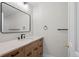 Bathroom featuring a modern vanity with stylish fixtures and a large decorative mirror at 7 Mockingbird Ln, Cherry Hills Village, CO 80113
