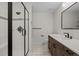 Bathroom features a glass enclosed shower, neutral tile, and stylish dark fixtures at 7 Mockingbird Ln, Cherry Hills Village, CO 80113